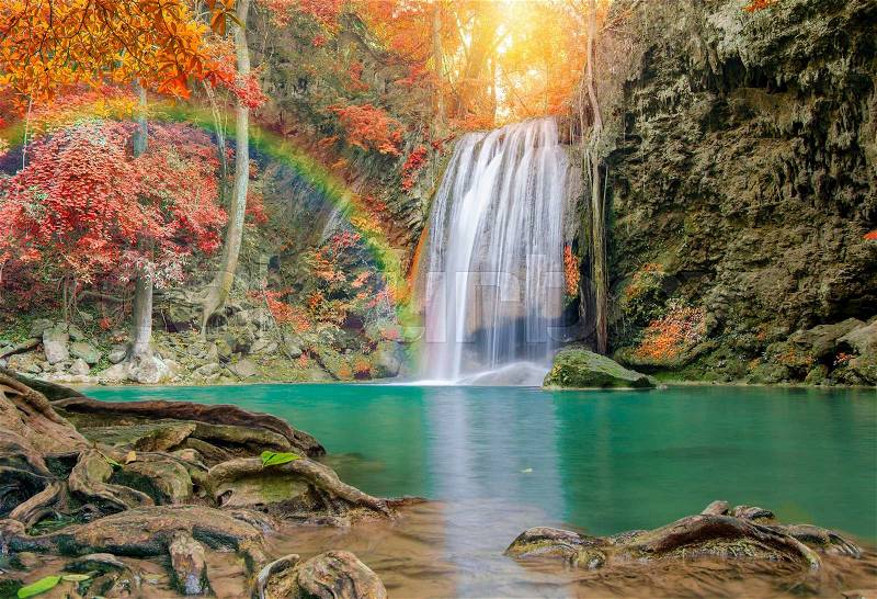 Wonderful Waterfall with rainbows and red leaf in Deep forest at Erawan waterfall National Park, Kanjanaburi Thailand, stock photo