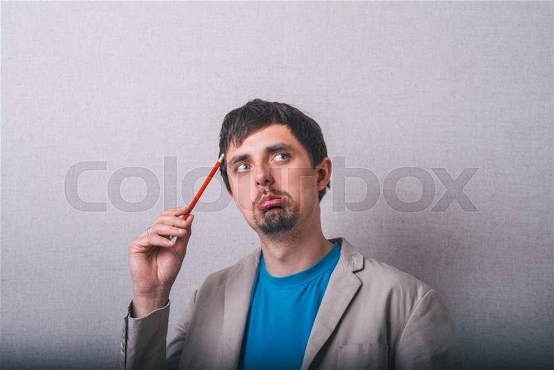 Man thinking about something with pencil, stock photo
