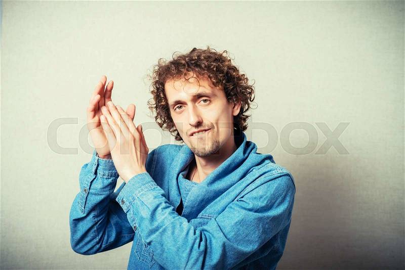 Attractive man clapping hands, stock photo