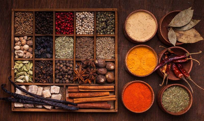 Different types of spices in wooden box, stock photo