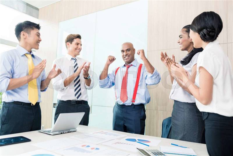 Indian CEO reporting success in business meeting, stock photo