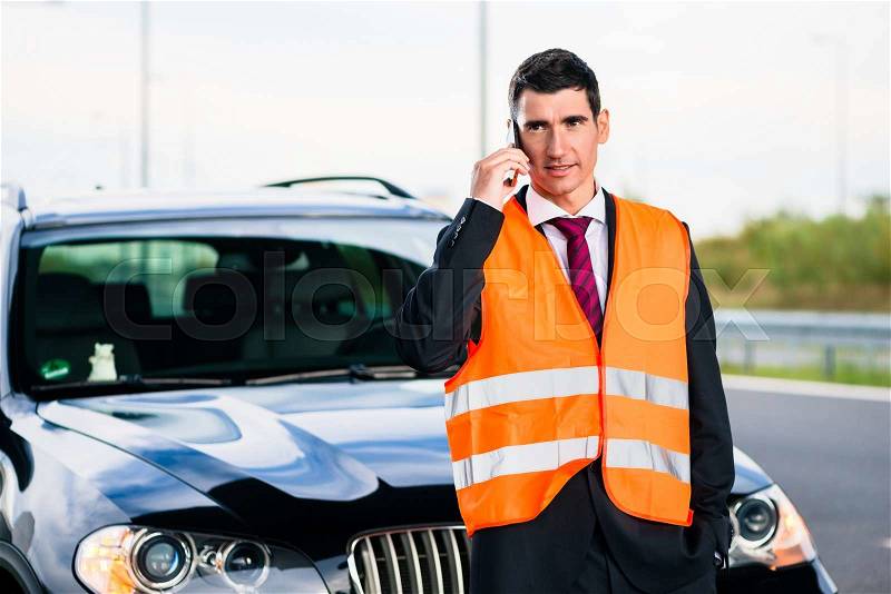 Man with car breakdown calling towing company, stock photo