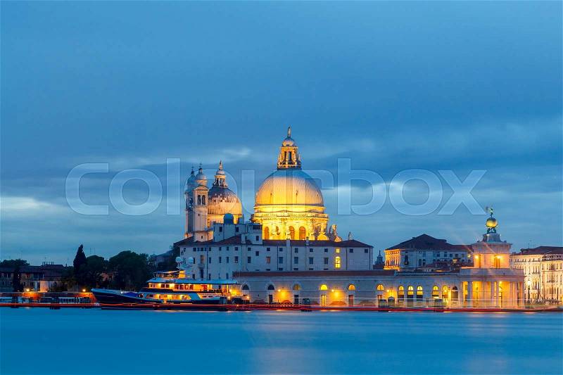View of the Basilica of Santa Maria della Salute with Venetian lagoon at night, stock photo