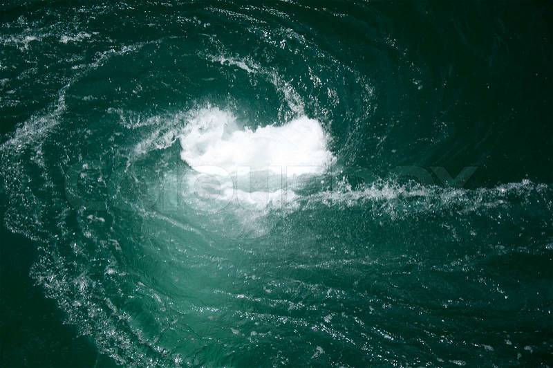A green water vortex that funnels below the surface, stock photo