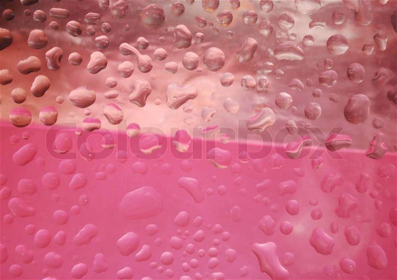 Multi coloured drops from water on glass, stock photo