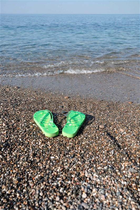 Holiday at the seaside - flip-flops on beach, stock photo