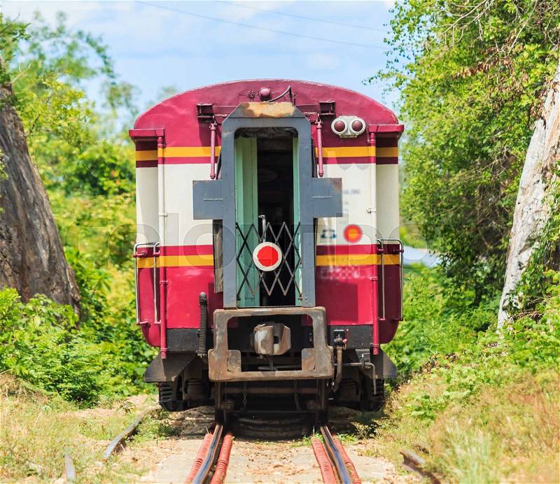 Train and tours train running past tunnel kanjanaburi,Thailand, stock photo