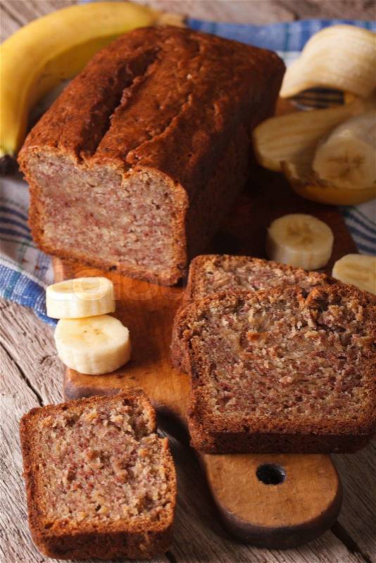 Homemade banana bread sliced on a table close-up. Vertical, rustic style\, stock photo