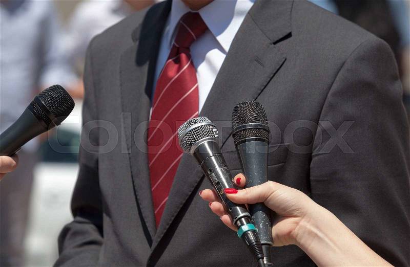 Journalists making interview with businessperson or politician, stock photo