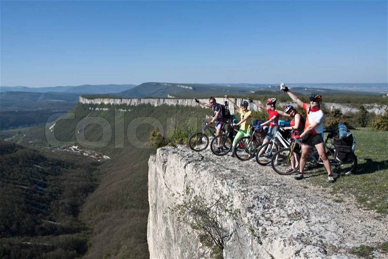 A group of five adults on bicycles in the countryside. Everyone can ride a bike. Everyone who rides a bike is my friend, stock photo