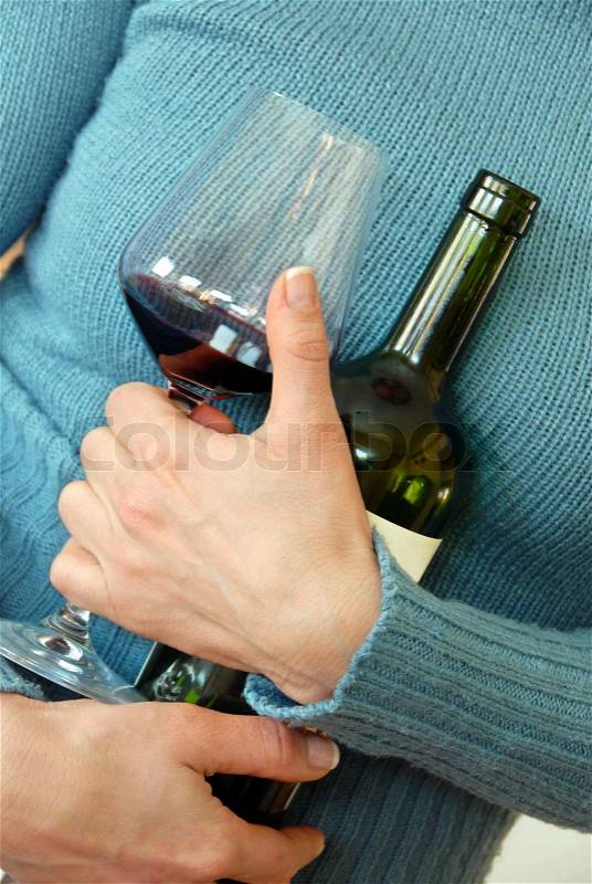 Wine glass and bottle in woman\'s hug, stock photo