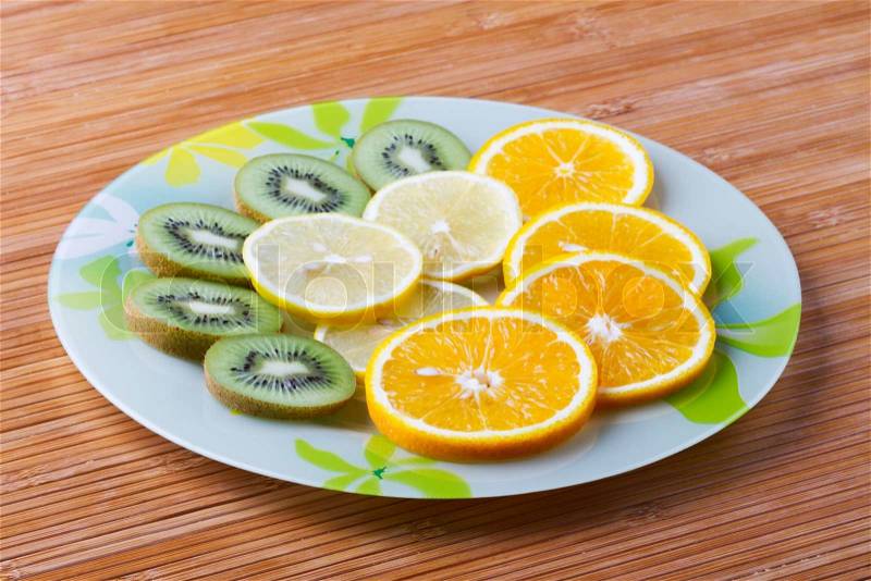 Tropical fruit cut by rings on a plate, stock photo