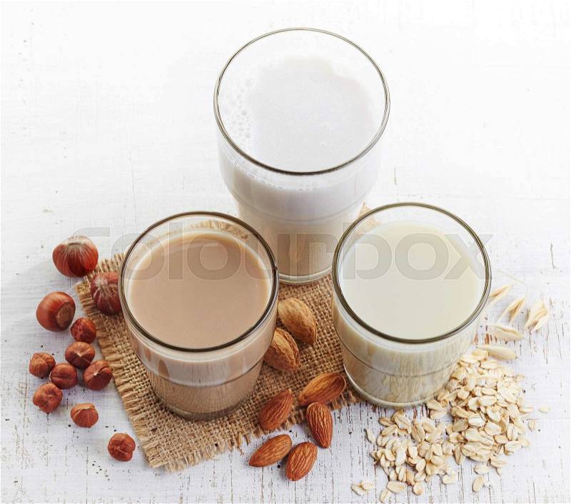 Different vegan milk: almond milk, hazelnut milk and oat milk, stock photo