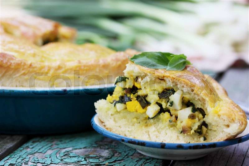 Homemade pie with onion, spinach and eggs, stock photo