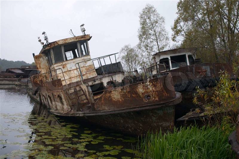 Blasted rusty boat in the river near of Chernobyl, stock photo