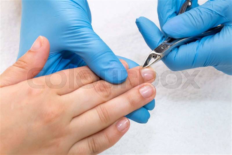 Woman doing manicure beauty salon varnish wellness, stock photo