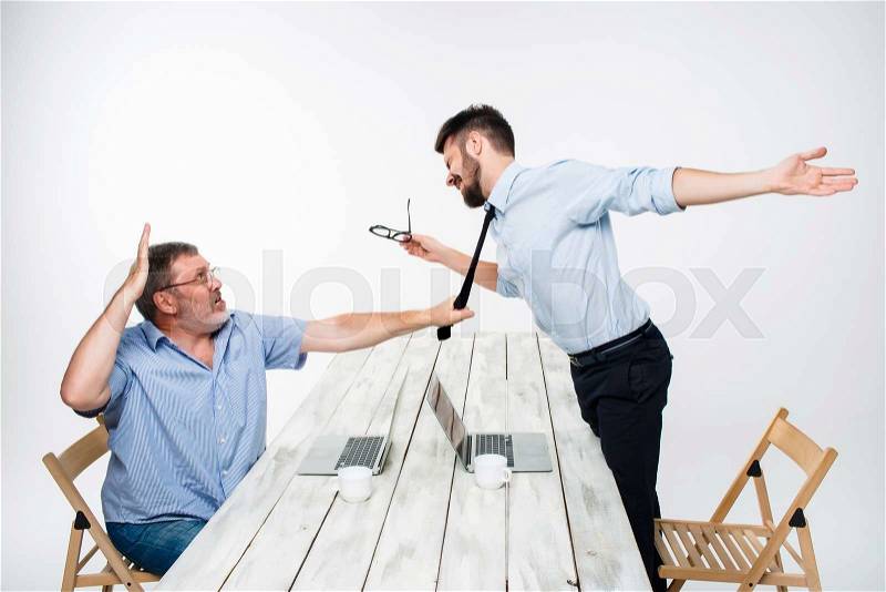 Business conflict. The two men expressing negativity while one man grabbing the necktie of her opponent on white background, stock photo