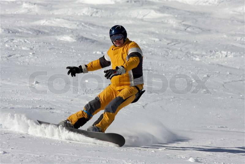 Snowboarder in yellow suite, stock photo