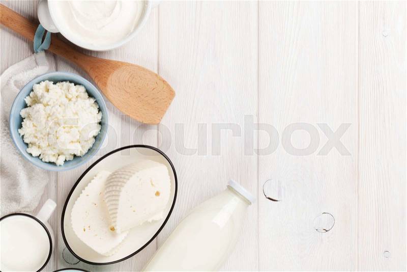 Dairy products on wooden table. Sour cream, milk, cheese and yogurt. Top view with copy space, stock photo