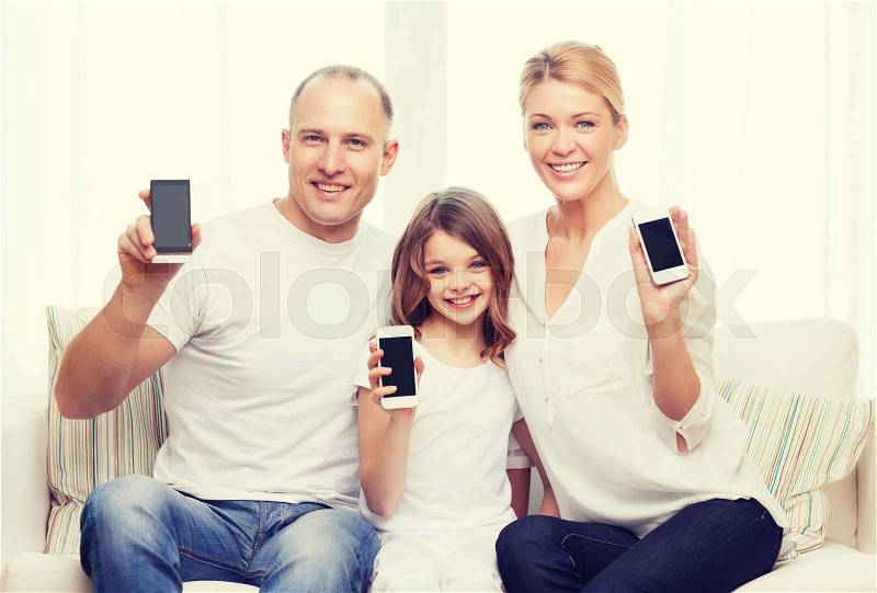 Family, child, technology and home concept - smiling parents and little girl with blank black screen smartphones at home, stock photo