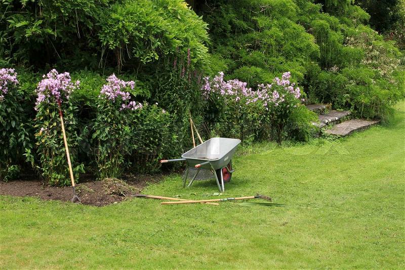 The gardener has a break in the wonderful garden in the summer in Ireland, stock photo