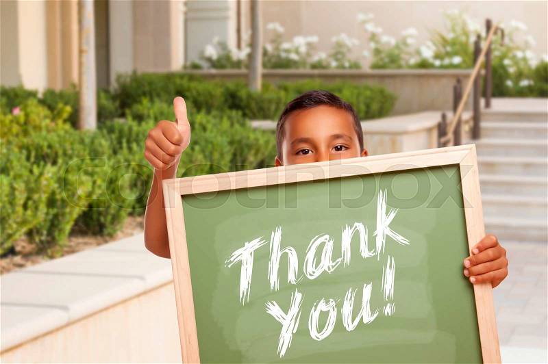 Happy Hispanic Boy Giving Thumbs Up Holding Thank You Chalk Board Outside on School Campus, stock photo