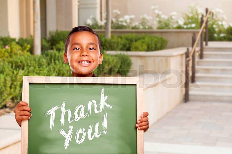 Happy Hispanic Boy Holding Thank You Chalk Board Outside on School Campus, stock photo