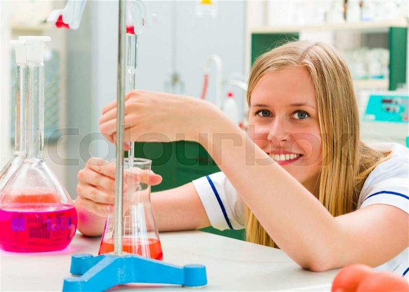 Determined young chemist working in the analytical laboratory, stock photo