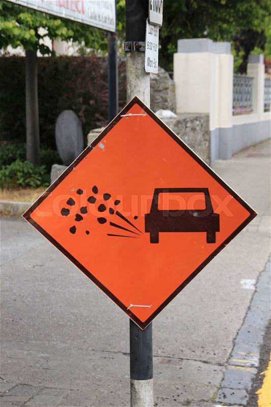 Warning road sign, splashing stones, be careful, stock photo