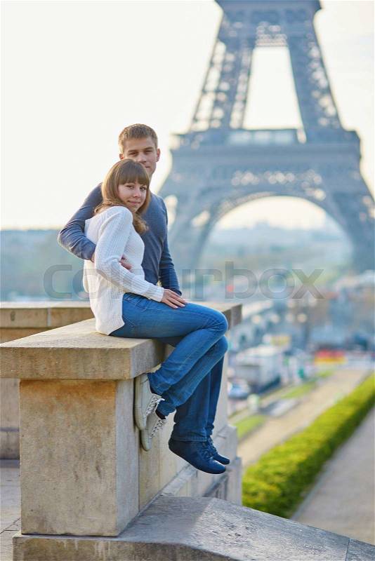 Young romantic couple in Paris having fun near the Eiffel tower, stock photo