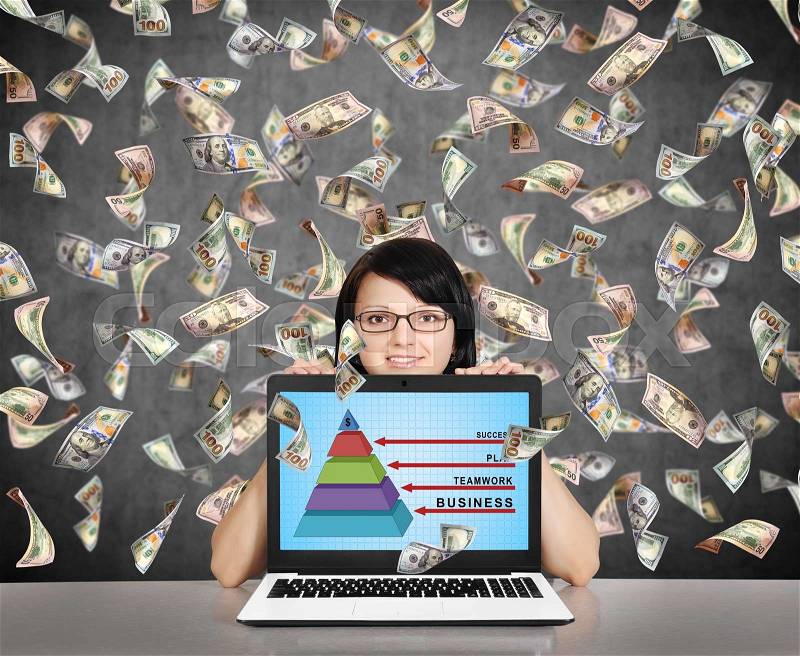 Businesswoman holding laptop with business pyramid and falling dollar bills, stock photo