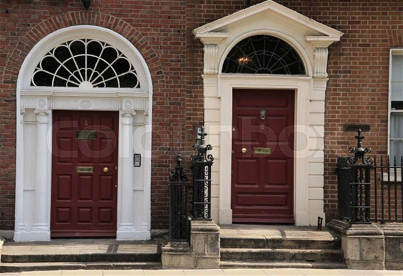 Two striking front doors of the building in one of the streets of the city Dublin in Ireland in the summer, stock photo