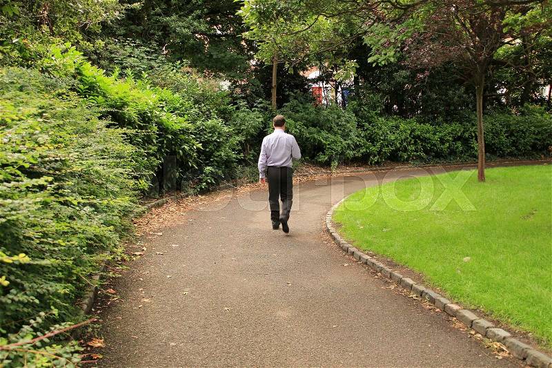 The man walks in Merrion Square Park in the city Dublin in the summer, stock photo