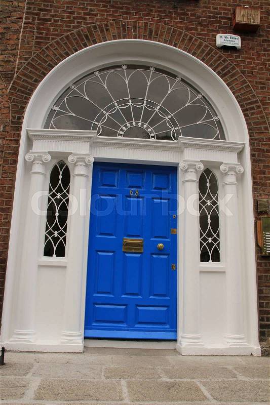 A striking blue front door in one of the famous streets in the city Dublin in Ireland in the summer, stock photo