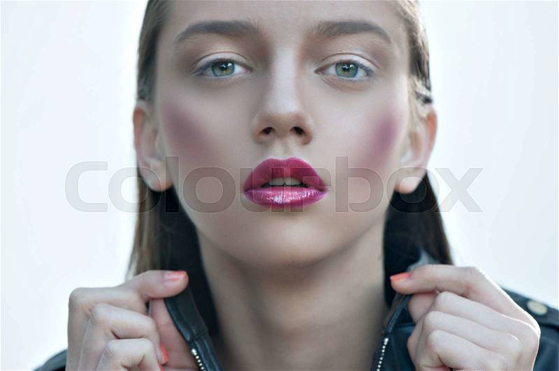 Fashion girl with pink lips posing in black leather jacket, stock photo
