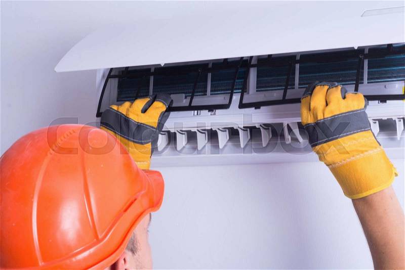 Placing back clean filter into air conditioner , stock photo