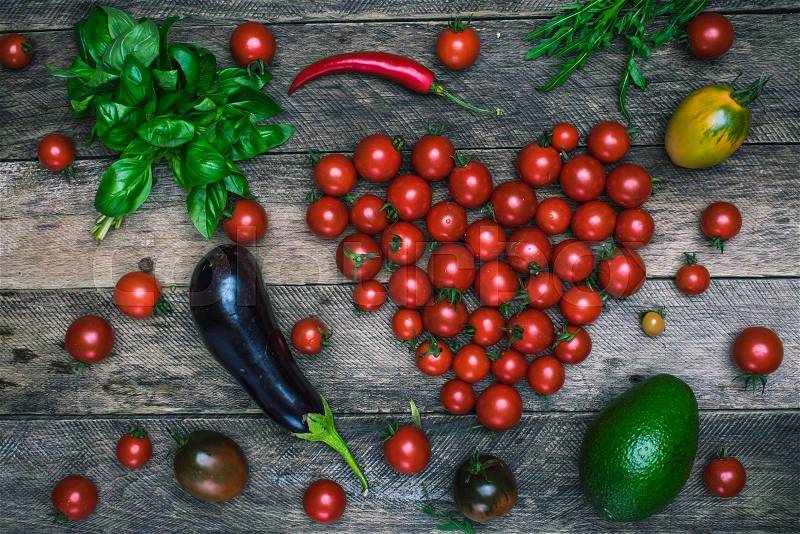 Tomato heart shape and vegetables as healthy lifestyle concept on wooden table it rustic style, stock photo