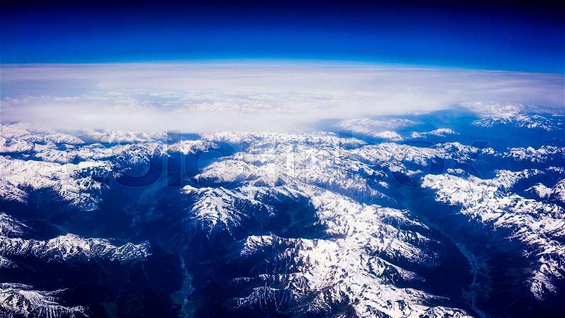 Landscape of Mountain. view from the airplane window. Aerial View of Snowy Mountain, stock photo