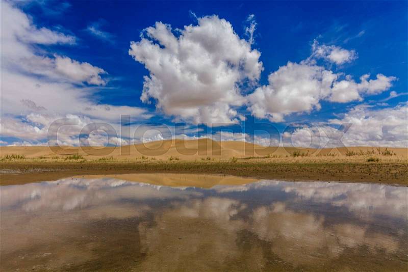 Gobi Desert after rain. Reflection of clouds in pools, stock photo