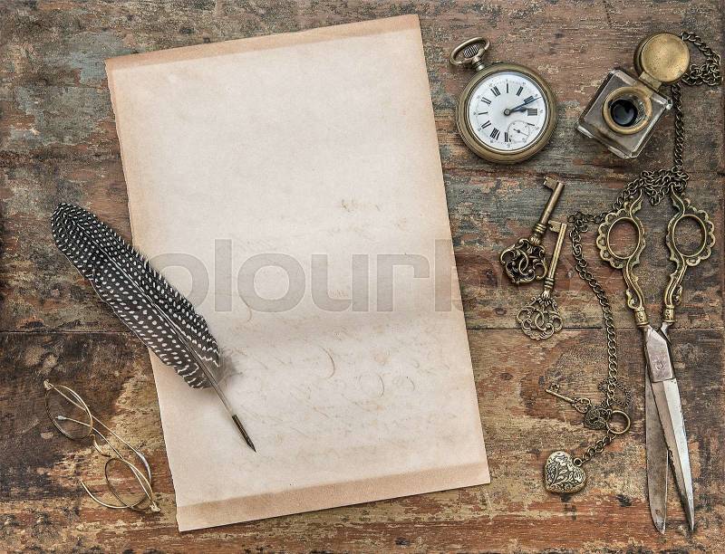 Letter paper and vintage writing tools. Feather pen, inkwell, keys on textured wooden background. Retro style toned picture, stock photo