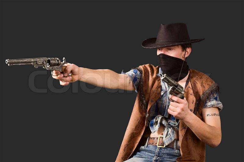 1453724-cowboy-with-revolvers-in-his-hands-isolated-on-dramatic-background-shallow-dof.jpg