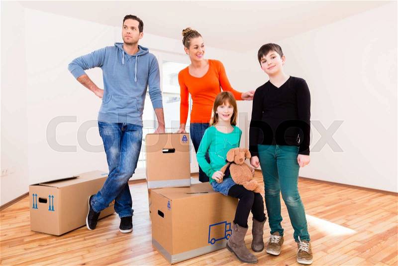 Family with moving boxes in new home or house looking around, stock photo
