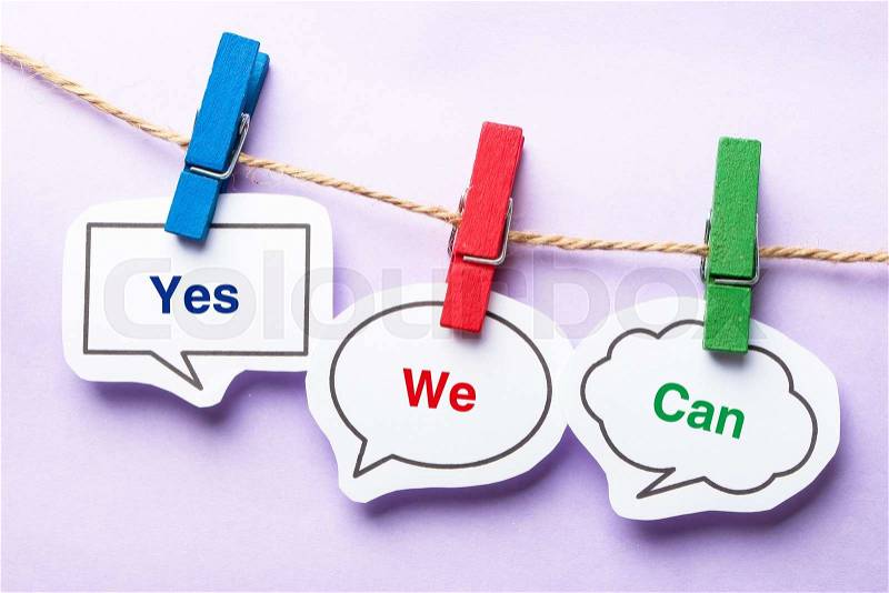 Yes we can paper bubbles with clip hanging on the line against purple background, stock photo