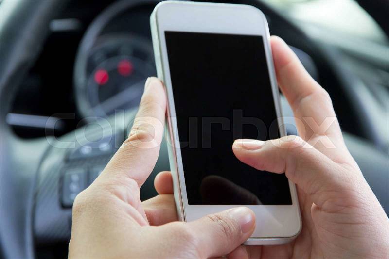Woman Sitting in the Car and Using Smart Phone, stock photo