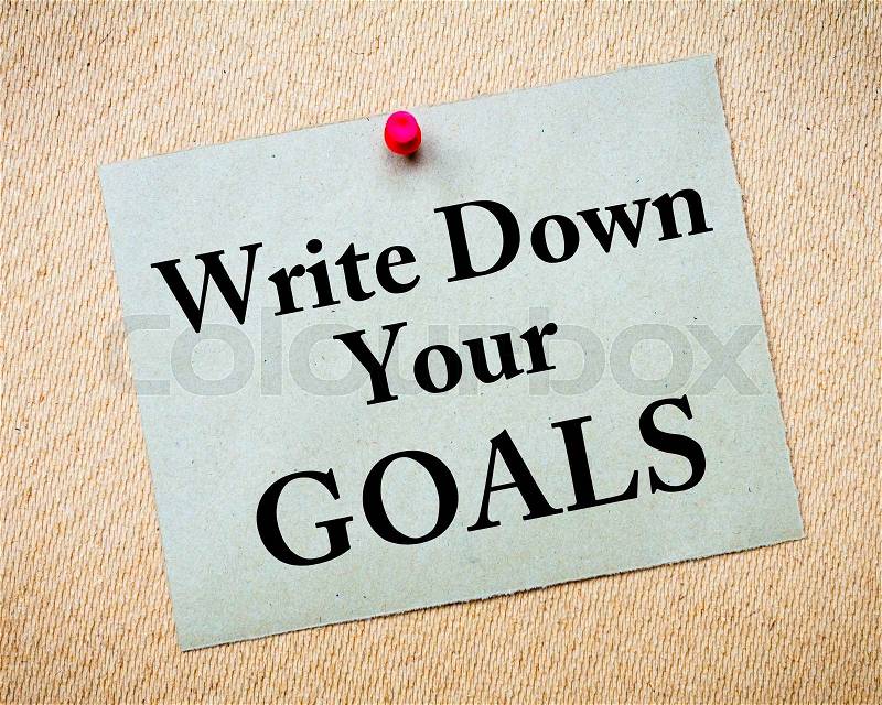 Write Down Your Goals Message written on recycled paper note pinned on cork board. Motivational concept Image, stock photo