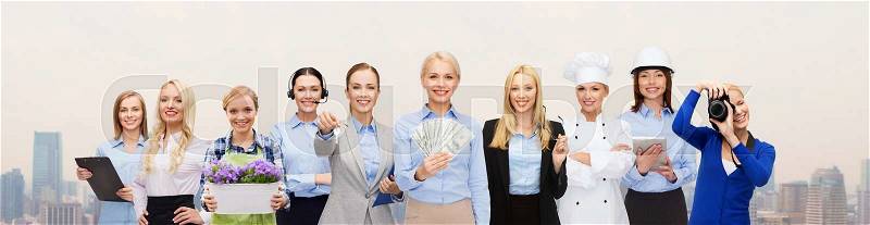 People, profession, employment, compensation and finances concept - happy businesswoman holding dollar money with group of professional workers over city background, stock photo