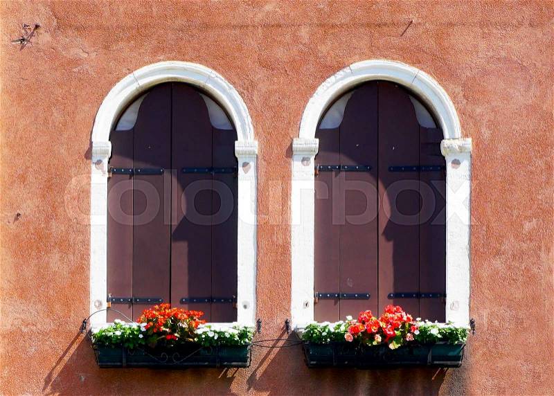 Two arch window and ancient decay orange wall building architecture in Murano, Venice, Italy, stock photo