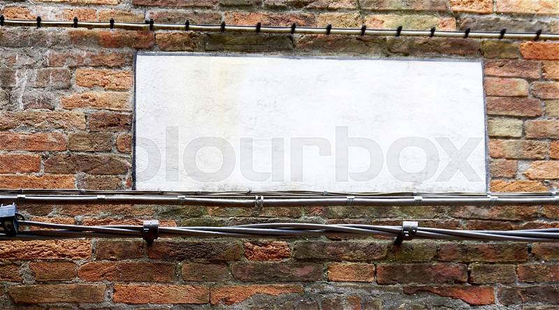 Blank sign on brick wall in Venice, Italy, stock photo