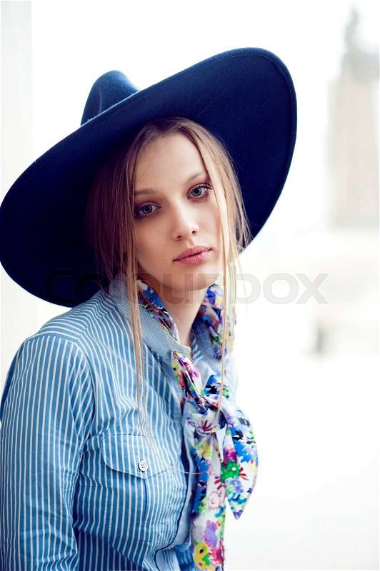 Fashion model in blue blouse and hat, stock photo