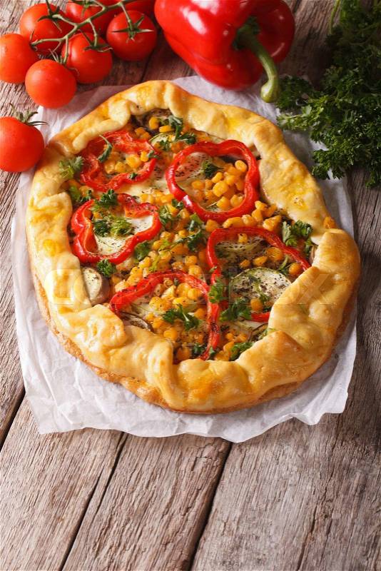 Rustic vegetable pie on a table close-up and ingredients. Vertical\, stock photo